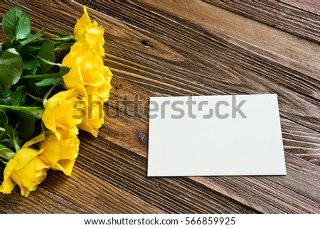 The bouquet of beautiful fresh yellow roses lies on a wooden table.
Card template by St. Valentine's Day or the international Women's Day.