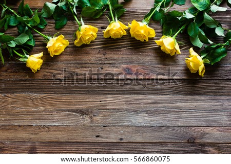 The bouquet of beautiful fresh yellow roses lies on a wooden table.
Card template by St. Valentine's Day or the international Women's Day.