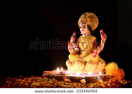Lakshmi - Hindu goddess, Goddess Lakshmi. Clay diya lamps lit with Goddess Lakshmi during Diwali Celebration. Greetings Card Design Indian Hindu Light Festival called Diwal