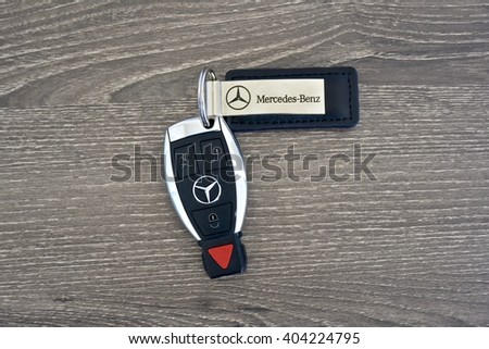 MARYLAND, USA - APRIL 10, 2016: A Mercedes-Benz key fob laying on a wood surface. Mercedes-Benz is a luxury car manufacturer and dealer.