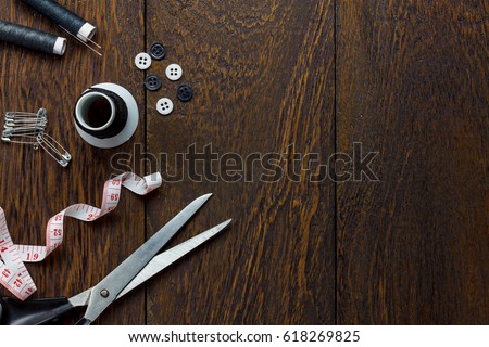 Top view tailor items on wooden background with copy space.