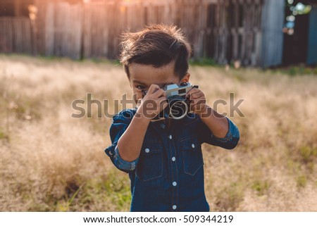 Little boy with a vintage camera,photographer boy
