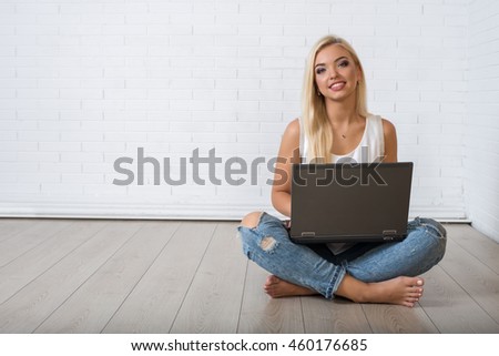 https://thumb7.shutterstock.com/display_pic_with_logo/3373661/460176685/stock-photo-attractive-blond-sexy-girl-in-jeans-and-shirt-is-sitting-with-a-laptop-on-the-background-of-a-white-460176685.jpg