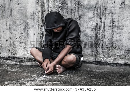 Drug abuse concept., overdose asian male drug addict hand, drugs narcotic syringe in action