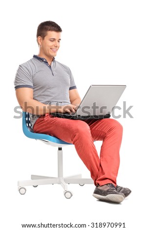 stock-photo-full-length-portrait-of-a-young-man-working-on-a-gray-laptop-seated-on-a-blue-chair-isolated-on-318970991.jpg