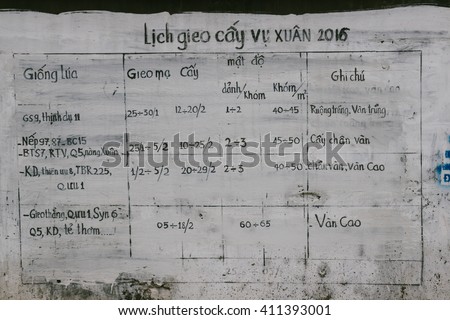 BAC NINH, VIETNAM - CIRCA FEBRUARY 2016: A community crops-planting calendar (2016) painted on a wall of a rural village in Bac Ninh province, Vietnam
