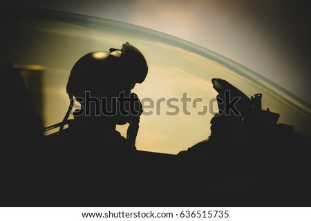 Jet pilot , clothing for pilots or pilots suit , The military pilot in the plane in a helmet in dark blue overalls against the blue sky