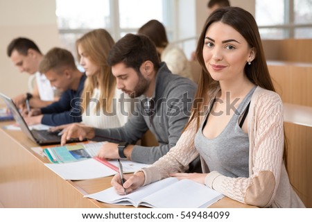 Diligent Student Beautiful Female Student Smiling To The Camera While Studying For Exams At University