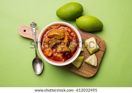 Homemade Mango Pickle or aam ka achar or achaar in white bowl, selective focus