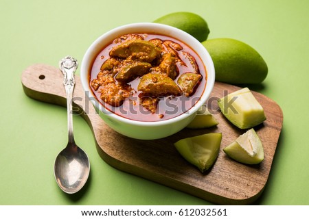 Homemade Mango Pickle or aam ka achar or achaar in white bowl, selective focus