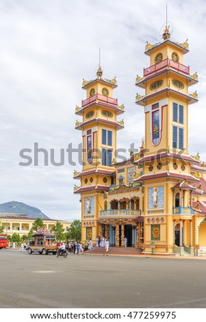 TAY NINH, VIETNAM - NOV 10, 2014:Cao Dai temple area and meditating followers of the Cao Dai religion in the temple Cao Dai
