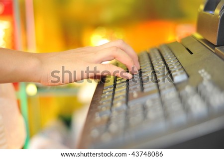 Woman's hand on cash register buttons