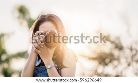 Young Asian woman photographer.