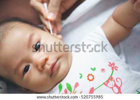 hungry asian baby sucking his fingers stock photo