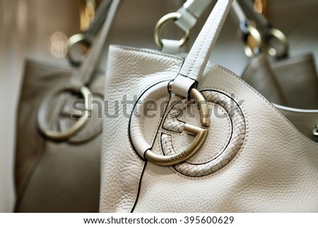 ROME, ITALY - 19 NOVEMBER 2012: A pair of Gucci 'Twill' bags bearing the interlocking "G" logo sit displayed for sale inside a Gucci store.