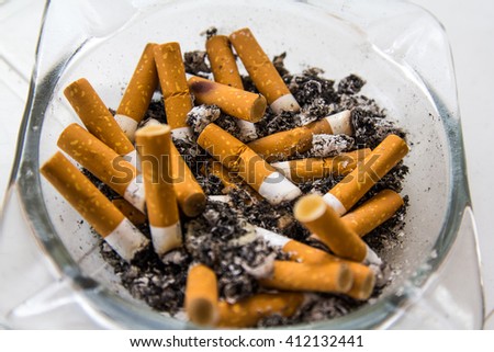 stock-photo-full-ashtray-with-smoked-cig
