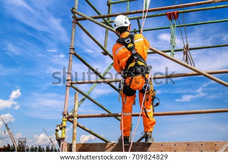 construction workers wearing safety harness belt during training at high place