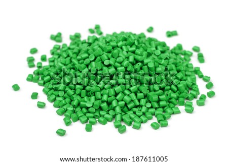 Pile of green polymer granules isolated on white
