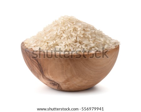 Uncooked dry rice in wooden bowl isolated on white