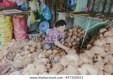 An Giang, Vietnam - October 12th, 2016: a portrait of woman with smile happy, she sells dry coconut.