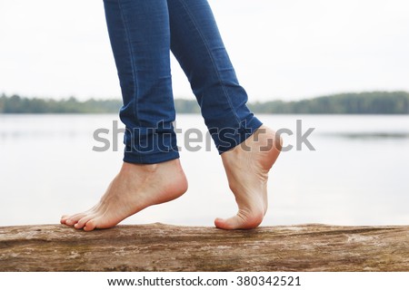 stock-photo-woman-s-feet-walking-on-a-log-380342521.jpg