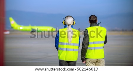 airport staff looking at aircraft