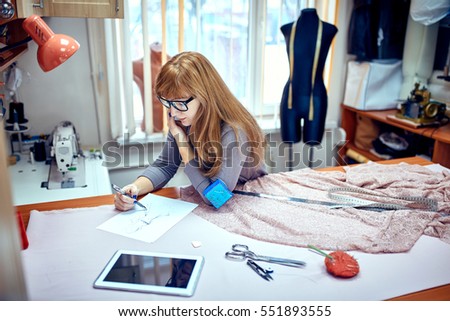 Fashion designer drawing sketches in studio