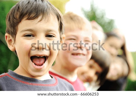 Photo of happy girls with handsome lads in front smiling at camera