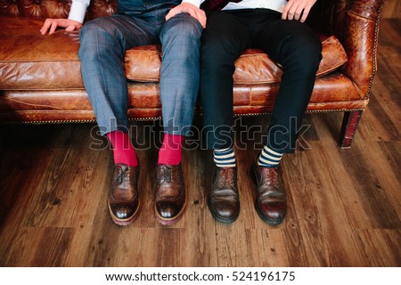 Men's feet in stylish shoes and bright socks