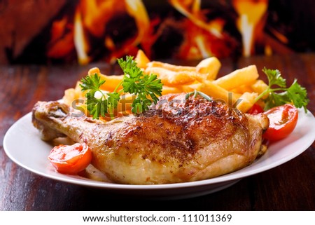 roasted chicken leg with fries potato and herbs - stock photo