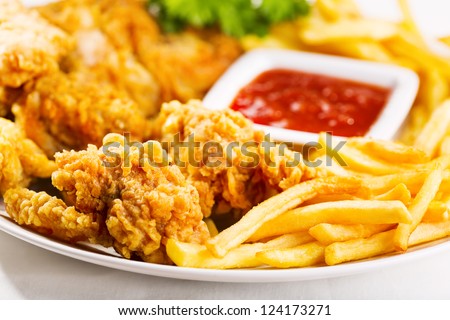 fried chicken with fries on a plate - stock photo