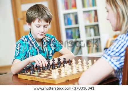 boy playing chess at home