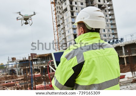 Drone operated by construction worker on building site