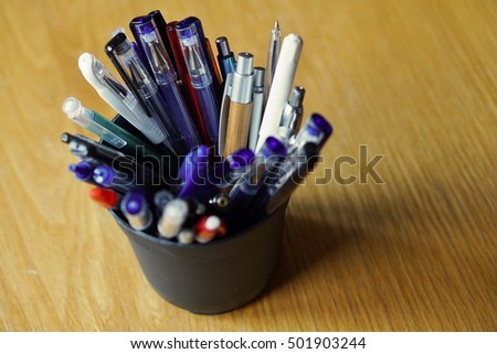 Writing utensils in the business environment with ball pens, highlighters and pens
