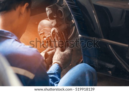 Selective focus disc brake on car, in process of new tire replacement,Car brake repairing in garage