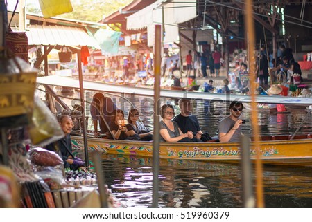DAMNOEN SADUAK, THAILAND - NOVEMBER 21: Damnoen Saduak Floating Market on Nov 21, 2016. Local people selling goods on the wooden boat. Damnoen Saduak is the most popular floating market in Thailand.