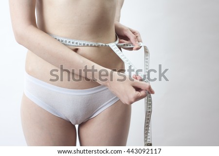 One Attractive Caucasian Girl In White Panties With A Centimeter Measuring Hips And Waist On White One Attractive Caucasian Girl In White Panties With A Centimeter Measuring Hips And Waist On White