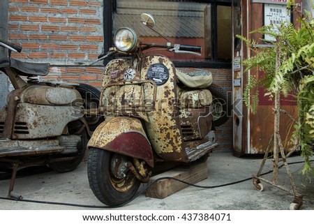 BANGKOK THAILAND JUNE 12 2016 Old Vintage Rusty Vespa Parked In Front Of Warehouse BANGKOK THAILAND JUNE 12 2016 Old Vintage Rusty Vespa Parked In Front Of Warehouse