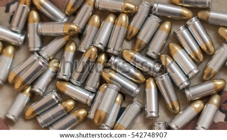 Silver Golden 9mm Bullets On Camouflage Stock Photo 542748907