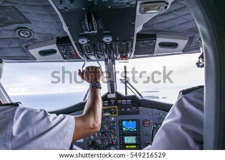 Interior details of a water plane with pilot and co pilot on board while flying. The photography is a demonstration of team work.