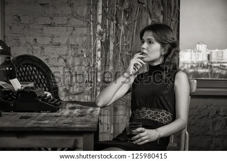 https://thumb7.shutterstock.com/display_pic_with_logo/398806/125980415/stock-photo-elegant-woman-in-black-at-the-table-with-the-old-typewriter-125980415.jpg