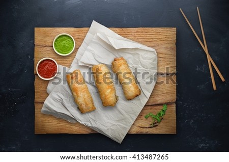 Spring rolls with rice on black background