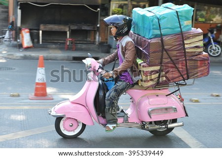stock-photo-bangkok-thailand-march-a-motorcyclist-rides-an-overloaded-vespa-on-a-city-street-the-395339449.jpg