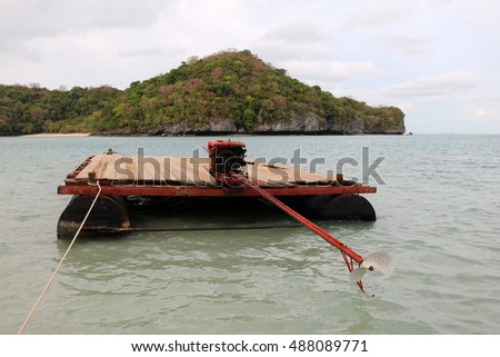 The raft with long-tail boats engine to transport materials in Thailand.