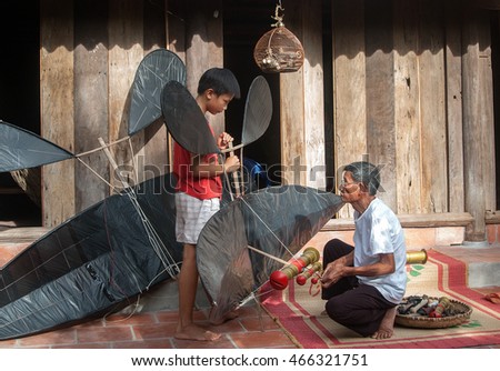 HAI DUONG, Vietnam, May 22, 2016 and her grandfather playing flute kite, summer, countryside Hai Duong, Vietnam