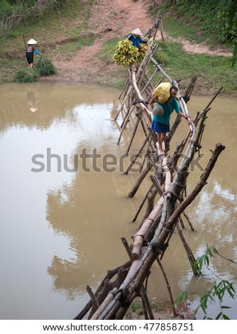 HAI DUONG, Vietnam, August 26, 2016 couple, going through bamboo bridges, waterways suburbs Hai Duong, Vietnam