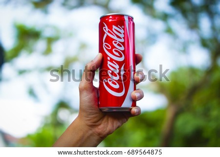 Kuala Lipis , Pahang , Malaysia 1st August 2017 - Hand Holding Coca Cola Can In Selective Focus Over Blur Background