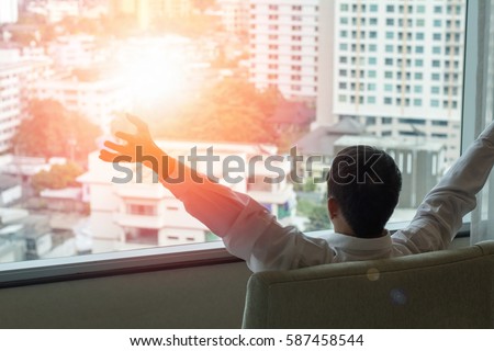 stock-photo-easy-relax-business-man-lifestyle-at-home-sitting-on-modern-chair-in-living-room-looking-out-of-587458544.jpg