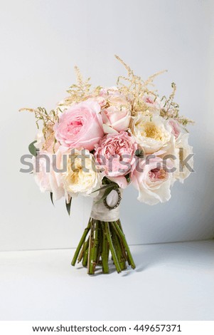 a bouquet of flowers on a white background wedding bouquet of pink and peach roses .