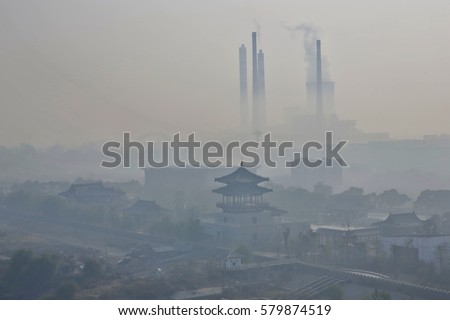 Severe fog and haze, power plants are the big chimney emissions along the Yangtze River in the eastern Chinese city of Jiujiang.